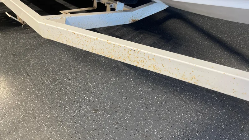 Slide: The Image of Rusty trailer frame for 2005 Chaparral 210 SSi boat on speckled floor. - 11