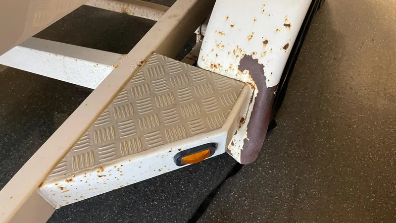 Slide: The Image of Rusty trailer step of 2005 Chaparral 210 SSi boat. - 12