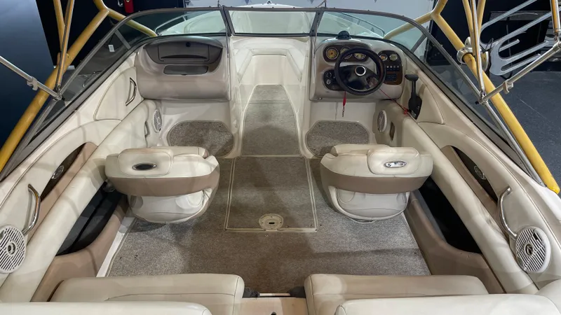 Slide: The Image of Interior of 2005 Chaparral 210 SSi boat with beige seating and steering console. - 14