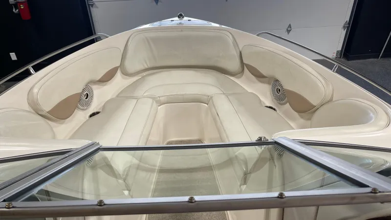Slide: The Image of 2005 Chaparral 210 SSi boat interior with beige seating and speakers. - 16