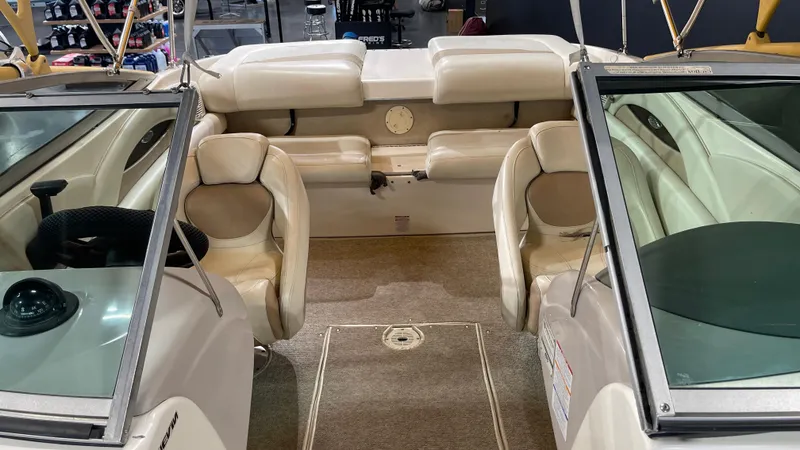 Slide: The Image of 2005 Chaparral 210 SSi boat interior with beige seating and carpeted floor. - 17