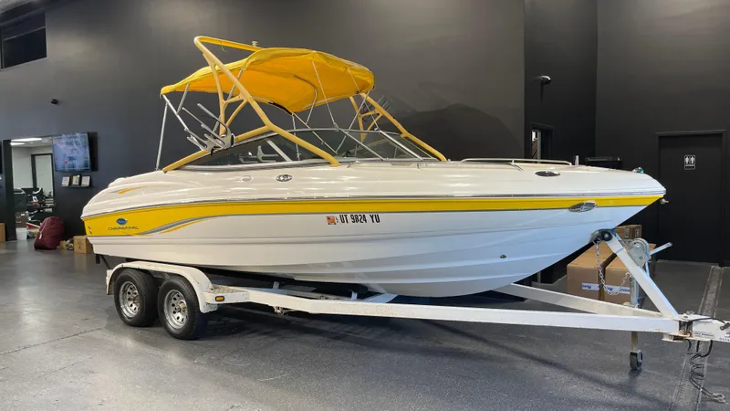 Slide: The Image of 2005 Chaparral 210 SSi boat with yellow canopy on trailer in showroom. - 2