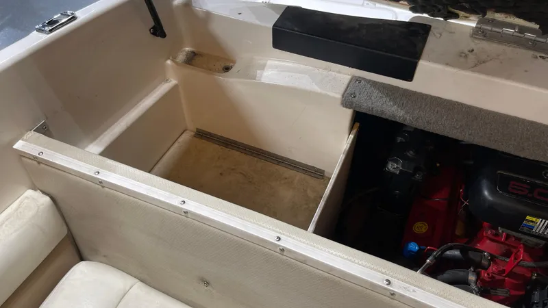 Slide: The Image of Interior view of a 2005 Chaparral 210 SSi boat showing storage compartment and engine area. - 24