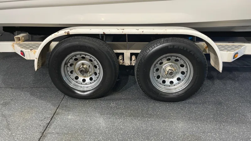 Slide: The Image of 2005 Chaparral 210 SSi trailer with dual wheels on a concrete surface. - 7