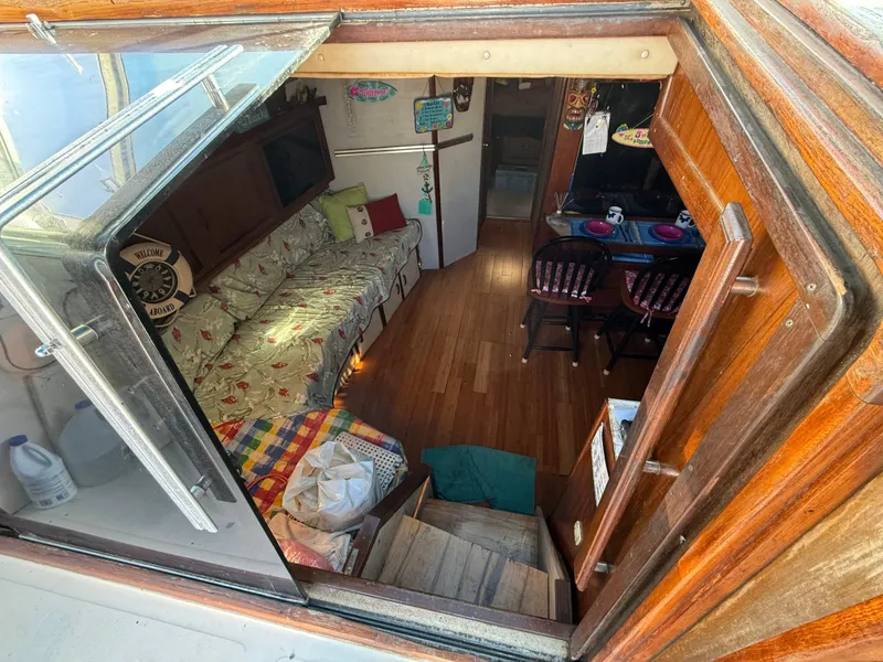Slide: The Image of Interior view of 1984 Sea Ray 390 Express Cruiser with cozy seating and dining area. - 11