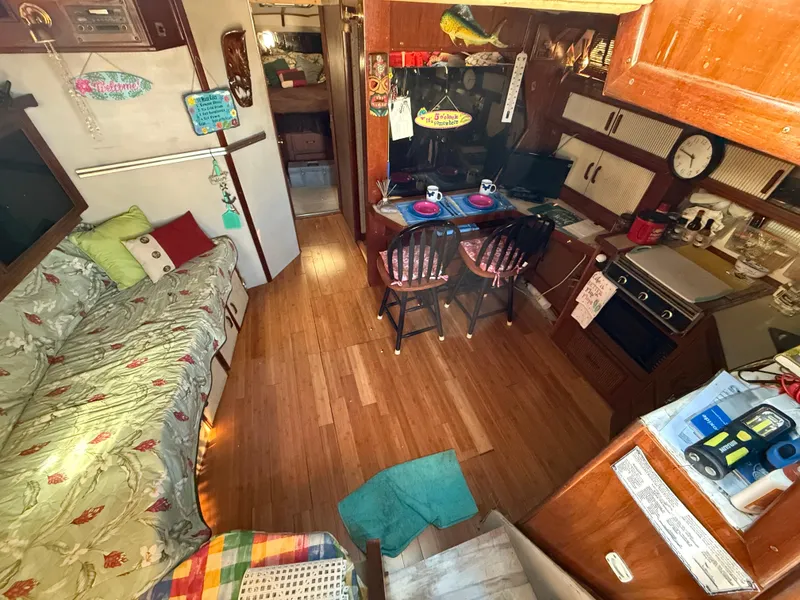 Slide: The Image of Interior of 1984 Sea Ray 390 Express Cruiser with cozy seating and kitchen area. - 12