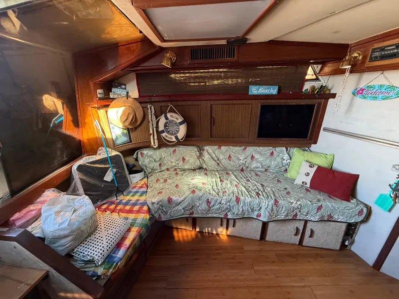 Slide: The Image of Cozy interior of 1984 Sea Ray 390 Express Cruiser with seating and decor. - 13