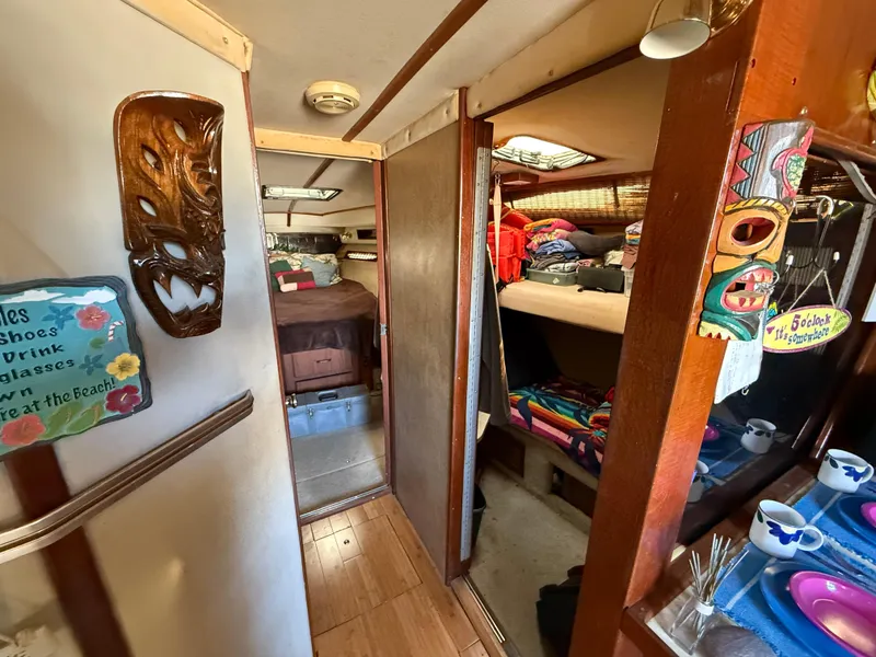 Slide: The Image of Interior of 1984 Sea Ray 390 Express Cruiser with cozy cabin and colorful decor. - 15