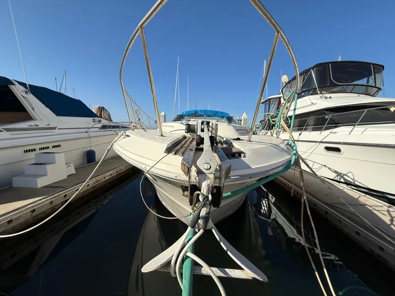 Slide: The Image of 1984 Sea Ray 390 Express Cruiser docked between boats. - 2