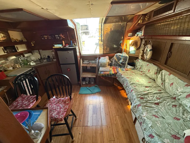 Slide: The Image of Interior of 1984 Sea Ray 390 Express Cruiser with cozy seating and kitchen area. - 24