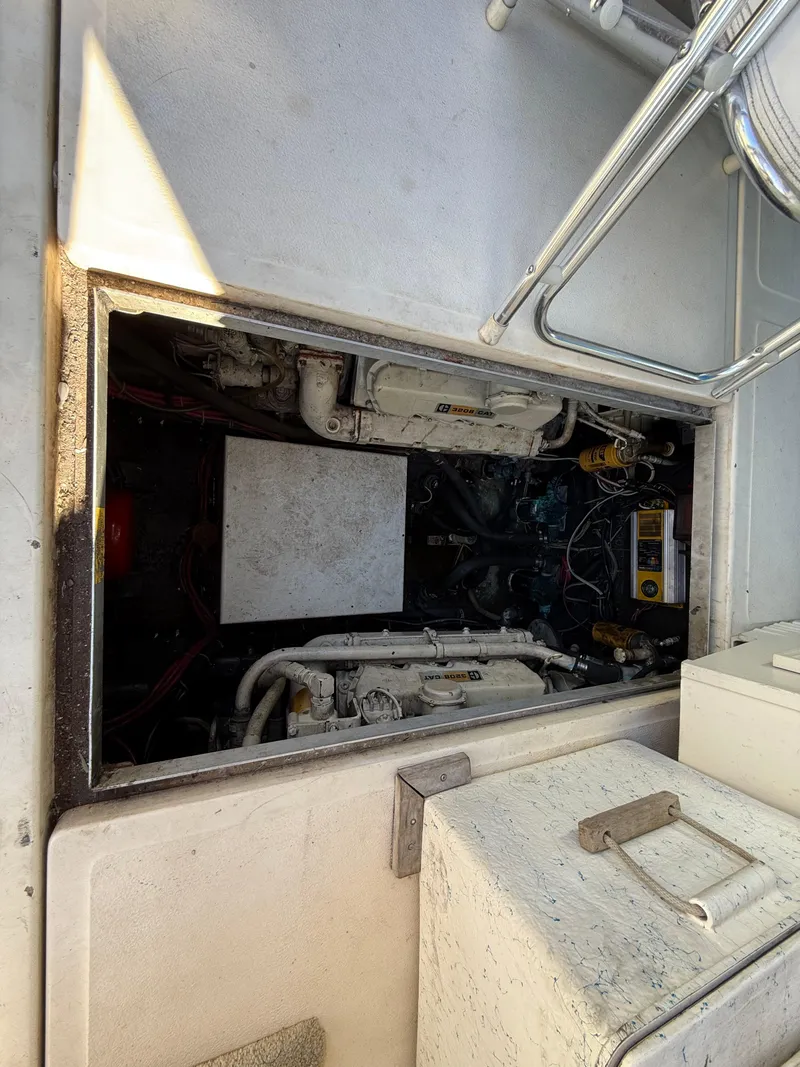Slide: The Image of Engine compartment of 1984 Sea Ray 390 Express Cruiser, showing mechanical components and wiring. - 25