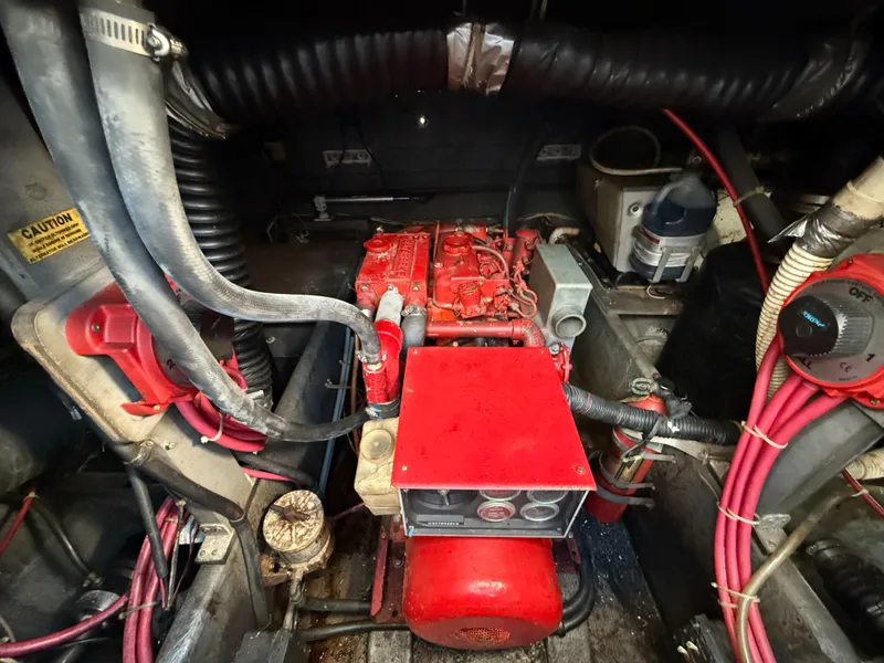 Slide: The Image of Engine compartment of 1984 Sea Ray 390 Express Cruiser with red engine components. - 30