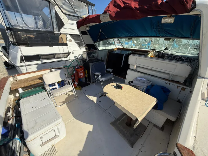 Slide: The Image of 1984 Sea Ray 390 Express Cruiser interior with seating, table, and marine equipment. - 5
