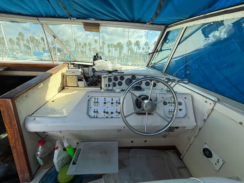 Slide: The Image of 1984 Sea Ray 390 Express Cruiser helm with steering wheel and control panel. - 6