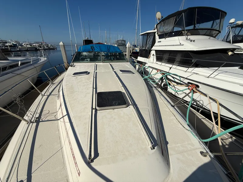 Slide: The Image of 1984 Sea Ray 390 Express Cruiser docked among other boats. - 9