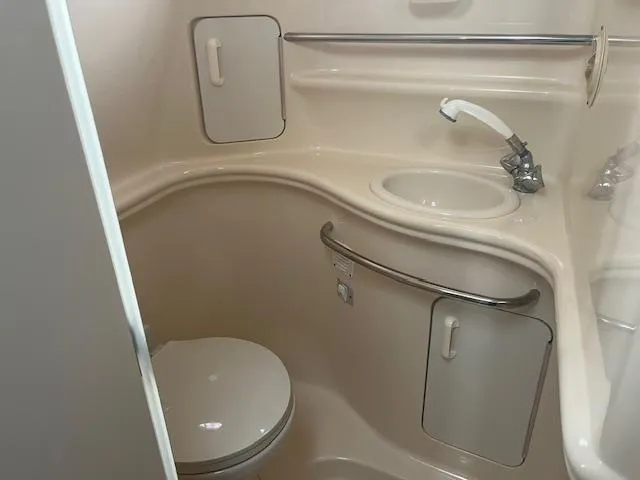 Slide: The Image of Compact bathroom in 2000 Sea Ray 340 Sundancer yacht with sink and toilet. - 14