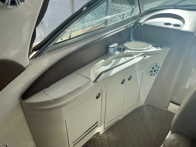 Slide: The Image of Interior of 2000 Sea Ray 340 Sundancer boat with sink and storage cabinets. - 15