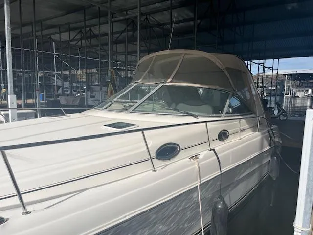 Slide: The Image of 2000 Sea Ray 340 Sundancer docked in a marina under a covered structure. - 3