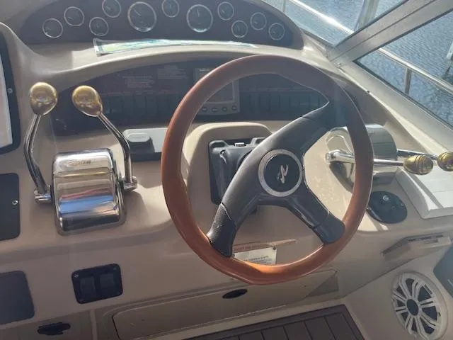 Slide: The Image of Steering wheel and controls of 2000 Sea Ray 340 Sundancer boat cockpit. - 5