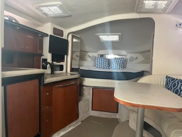 Slide: The Image of Interior of 2000 Sea Ray 340 Sundancer yacht with cozy cabin and kitchenette. - 8
