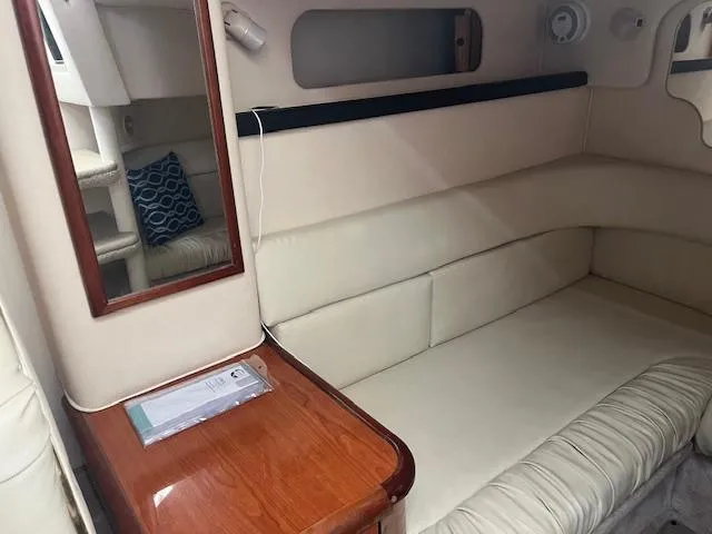 Slide: The Image of Interior of 2000 Sea Ray 340 Sundancer with cream seating and wooden accents. - 9