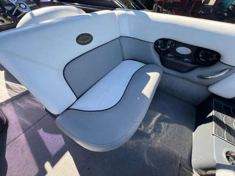 Slide: The Image of 2007 Supra 24SSV boat interior with gray and white seating and built-in speakers. - 11
