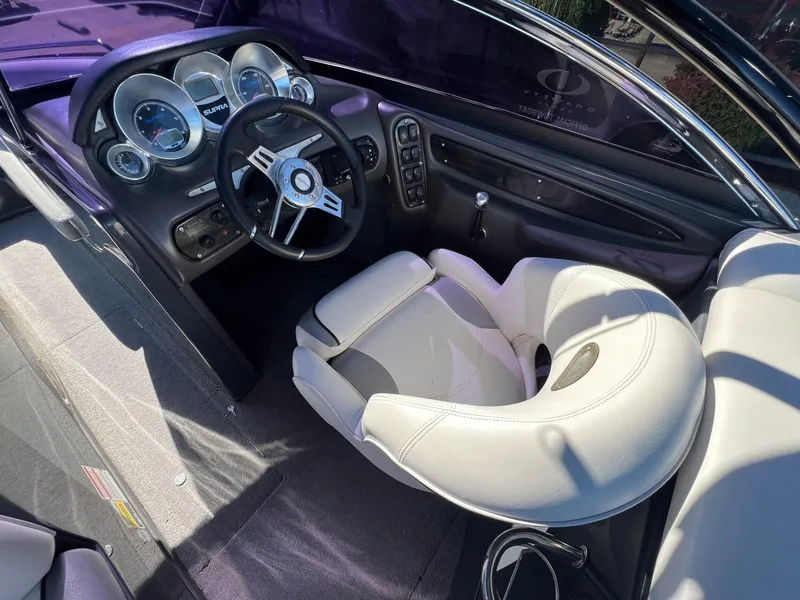 Slide: The Image of 2007 Supra 24SSV boat interior with steering wheel and dashboard controls. - 12
