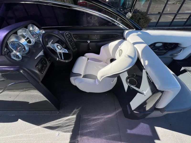 Slide: The Image of 2007 Supra 24SSV boat interior with steering wheel and dashboard controls. - 13