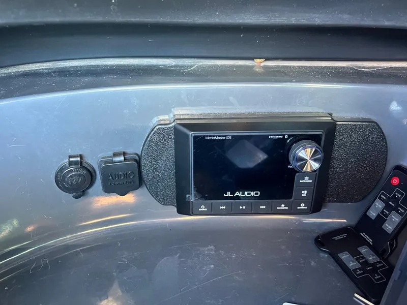 Slide: The Image of 2007 Supra 24SSV dashboard featuring JL Audio system and control panel. - 15