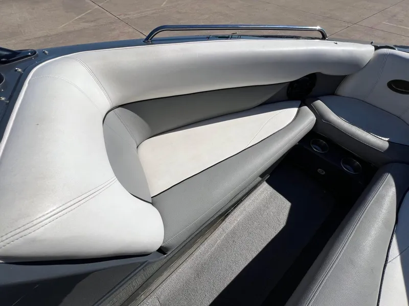Slide: The Image of 2007 Supra 24SSV boat interior with gray and white seating, cup holders, and sleek design. - 16