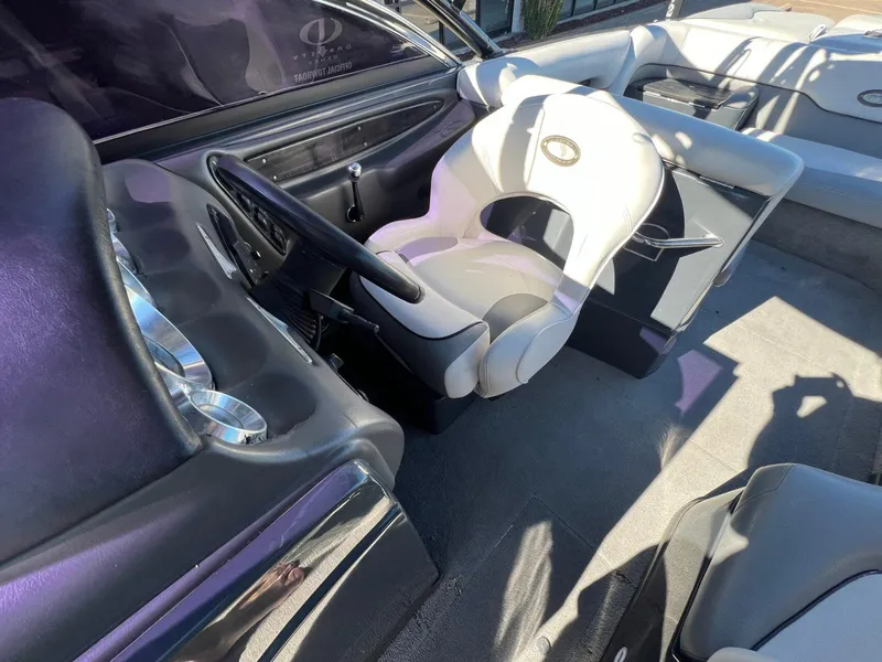 Slide: The Image of 2007 Supra 24SSV boat interior with steering wheel and seating. - 19