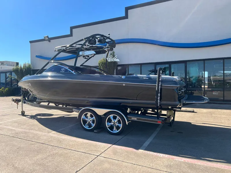 Slide: The Image of 2007 Supra 24SSV boat on trailer, parked outside a building on a sunny day. - 3