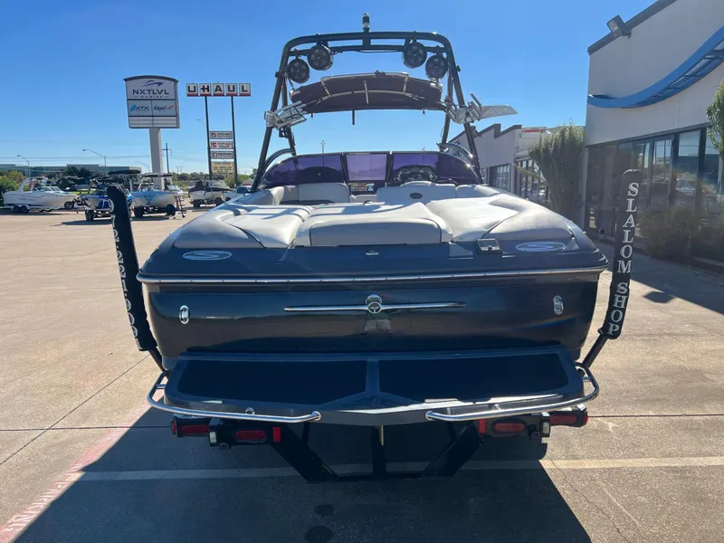 Slide: The Image of 2007 Supra 24SSV boat parked at dealership with clear blue sky. - 4