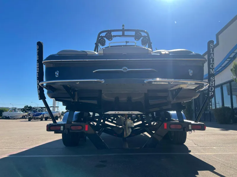 Slide: The Image of 2007 Supra 24SSV boat on trailer at Slalom Shop under clear blue sky. - 5