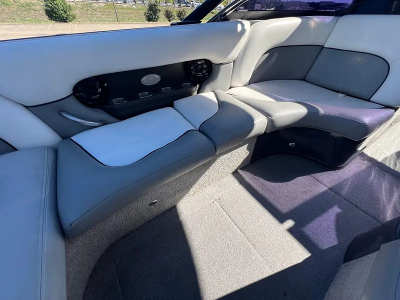Slide: The Image of 2007 Supra 24SSV boat interior with gray and white seating, featuring built-in speakers. - 9