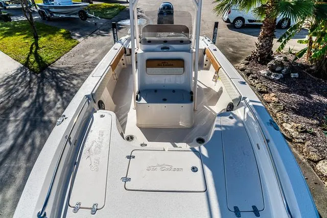 Slide: The Image of 2025 Carolina Skiff 23LX boat interior with seating and storage compartments. - 12