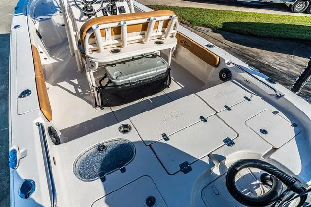 Slide: The Image of 2025 Carolina Skiff 23LX boat interior with seating and storage compartments. - 17
