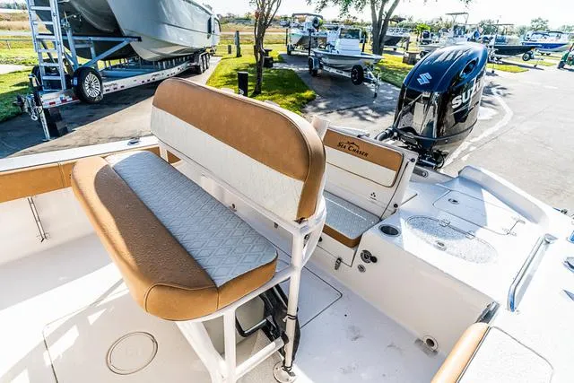 Slide: The Image of 2025 Carolina Skiff 23LX boat interior with seating and Suzuki outboard motor. - 6