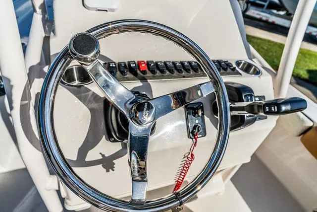 Slide: The Image of Steering wheel and controls of 2025 Carolina Skiff 23LX boat. - 7
