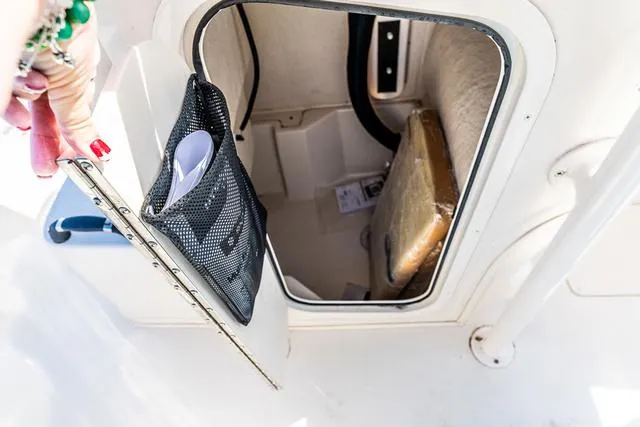 Slide: The Image of Storage compartment in 2025 Carolina Skiff 23LX boat, featuring organized interior space. - 8