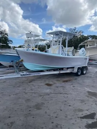 Slide: The Image of 2025 Exuma 22 CC boat on trailer under cloudy sky. - 1