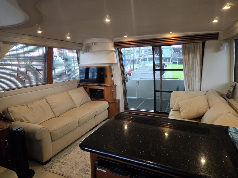 Slide: The Image of Interior of 2004 Carver 460 Voyager yacht with beige sofas and modern amenities. - 10