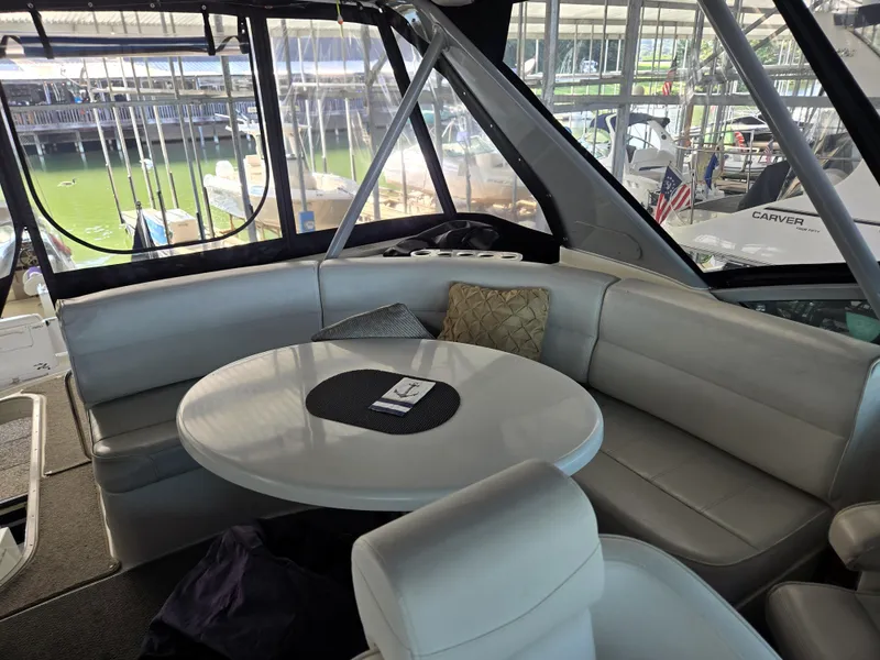 Slide: The Image of Interior of 2004 Carver 460 Voyager yacht with plush seating and round table. - 12