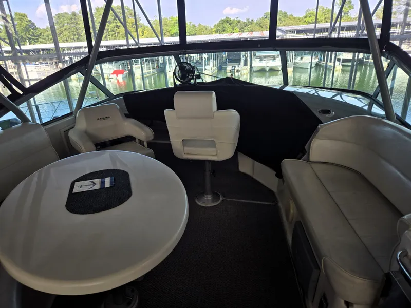 Slide: The Image of Interior of 2004 Carver 460 Voyager yacht with seating and table, docked at marina. - 13