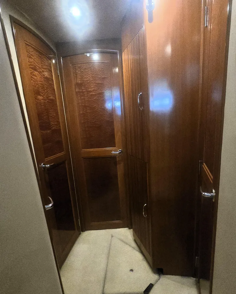 Slide: The Image of Interior hallway of 2004 Carver 460 Voyager yacht with wooden doors and soft lighting. - 15