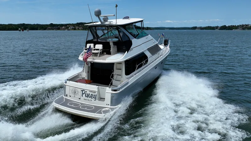 Slide: The Image of 2004 Carver 460 Voyager yacht cruising on open water. - 2