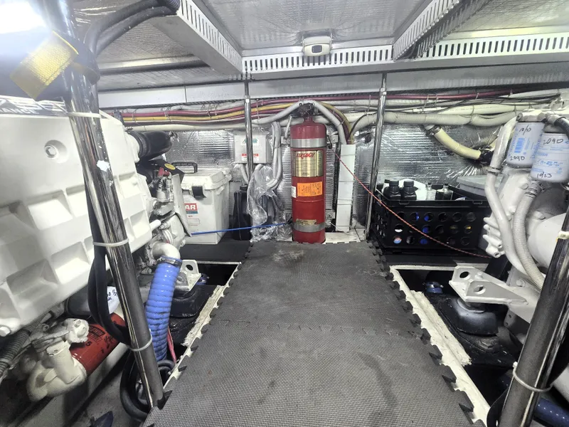 Slide: The Image of Engine room of 2004 Carver 460 Voyager yacht with visible machinery and fire extinguisher. - 20