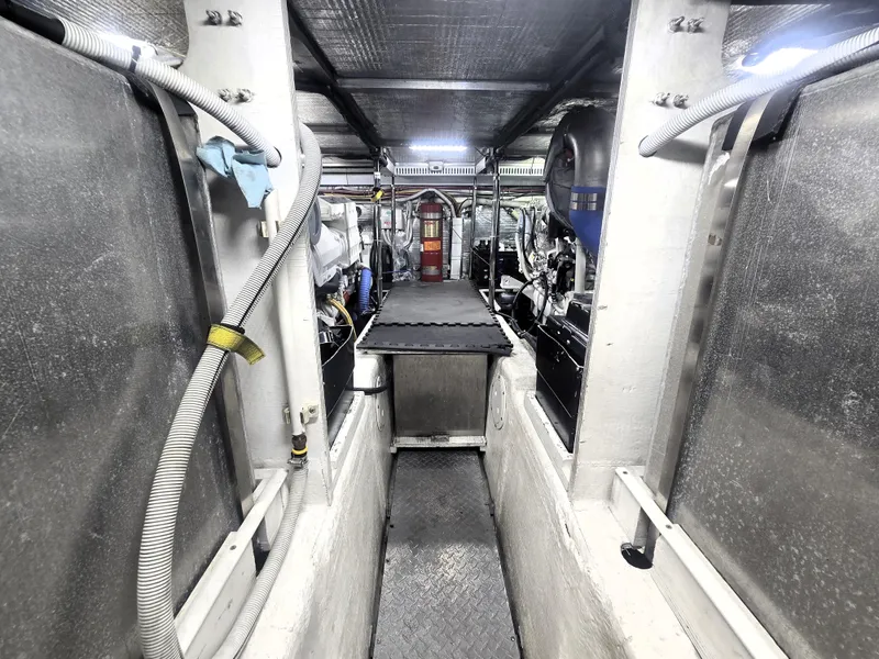 Slide: The Image of Engine room of 2004 Carver 460 Voyager yacht, showcasing mechanical components and wiring. - 21