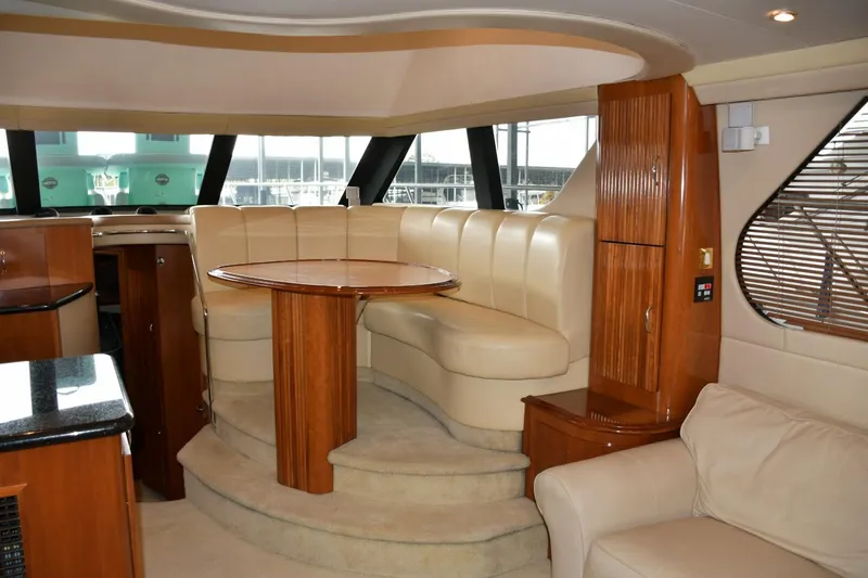 Slide: The Image of Luxurious interior of 2004 Carver 460 Voyager yacht with plush seating and elegant wood finishes. - 6