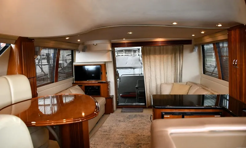 Slide: The Image of Luxurious interior of a 2004 Carver 460 Voyager yacht with elegant seating and wood finishes. - 8